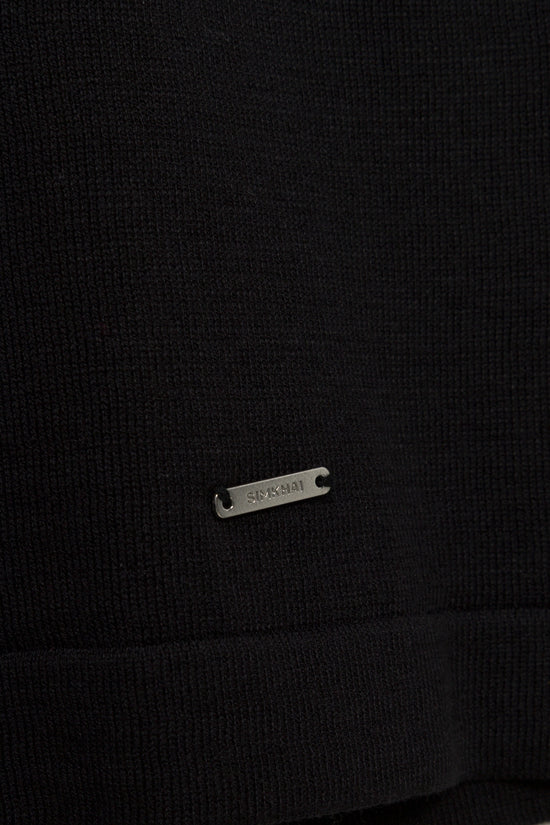 Black ribbed t-shirt with small metal rectangular logo plate on chest.