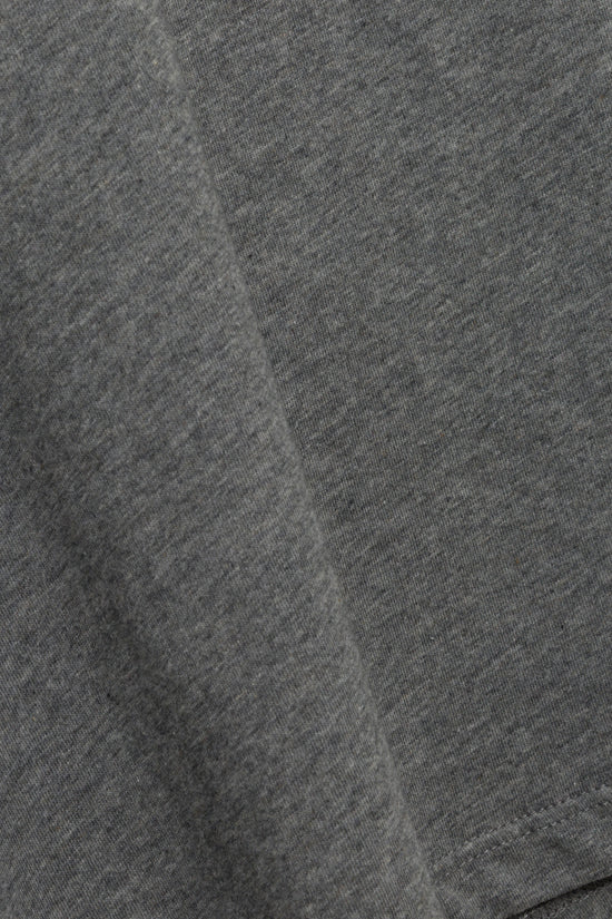 Close-up of gray cotton fabric with ribbed crewneck texture and center seam detail.