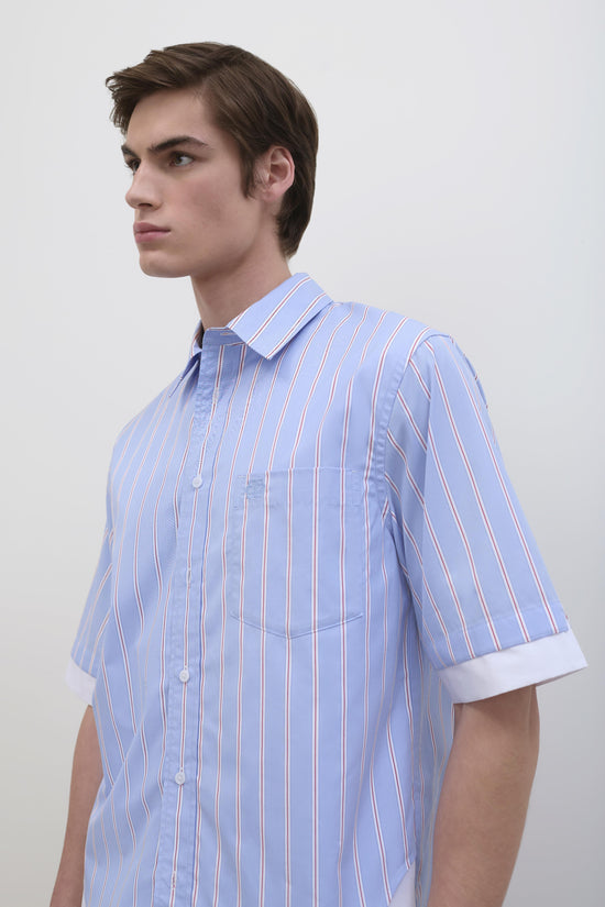 Man wearing light blue short-sleeve button-up shirt with white and red vertical stripes and rolled cuffs.