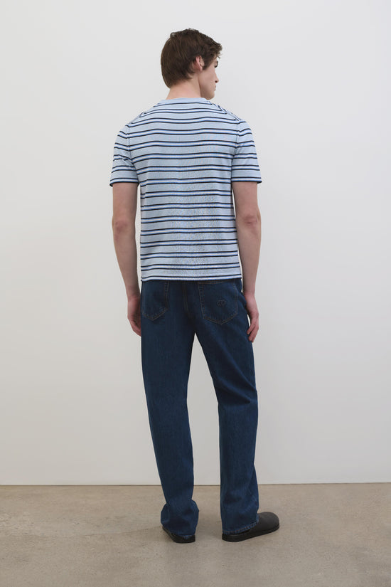 Man wearing light blue striped short-sleeve tee with dark blue and navy horizontal stripes, shown from back.