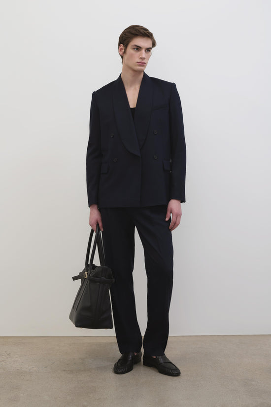 Black flat-front trousers with straight leg and high waist, worn with matching double-breasted blazer.