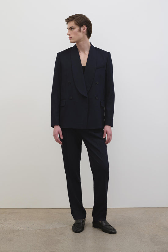 Black straight-leg trousers styled with a double-breasted blazer and black shoes.