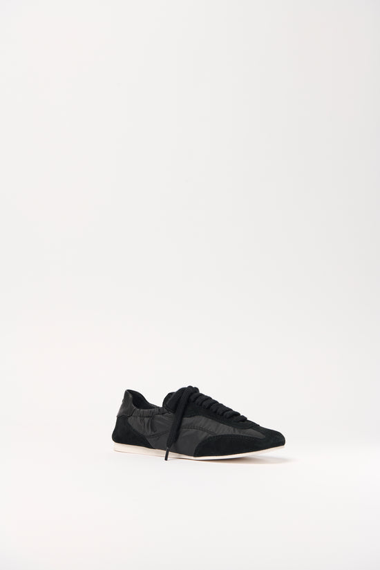 Black nylon and suede sneaker with lace-up closure and cream-colored sole.