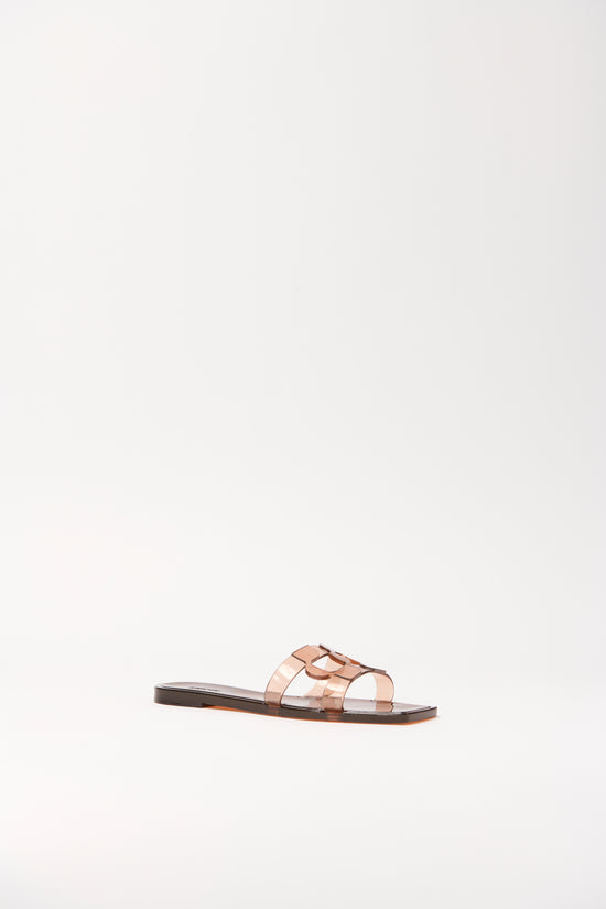 Clear jelly flat slide with monogram cutout design and dark sole.