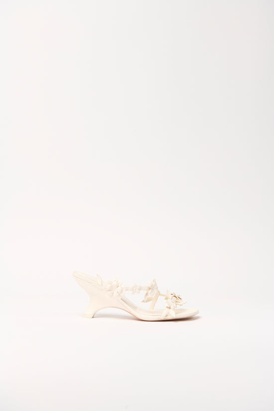 Cream leather sandal with strappy design and buckle detail, shown in profile view.