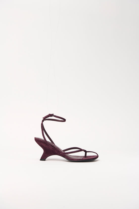 Burgundy suede wedge sandal with thin straps across the foot and ankle strap closure.