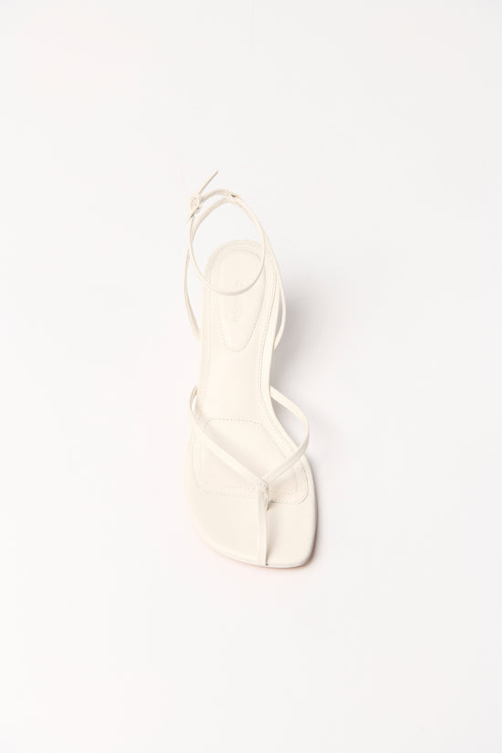 Cream leather strappy wedge sandal with ankle tie, shown from the back.