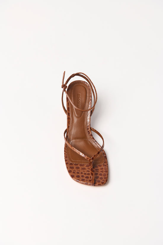 Brown leather strappy wedge sandal with crocodile-textured toe box and ankle lace-up closure, shown from above.