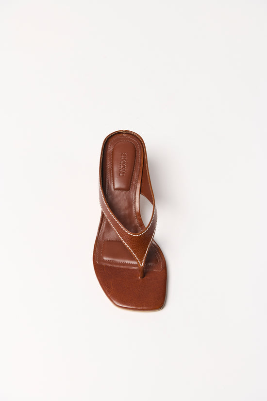 Brown leather thong wedge sandal with square toe and padded footbed, shown from above.