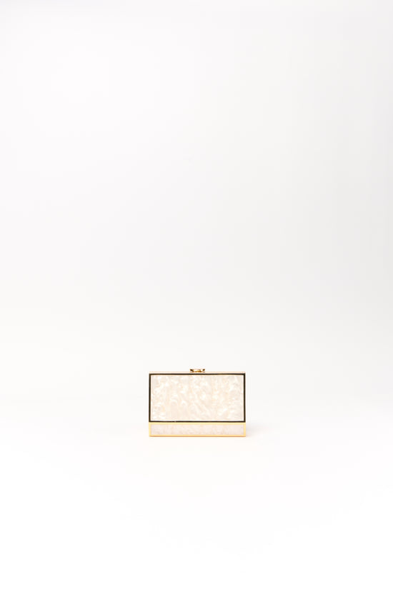 Cream pearl clutch with brown frame detail and gold-tone metal base.