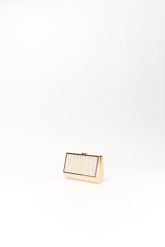 Cream and gold rectangular clutch with textured front panel and metal frame closure.
