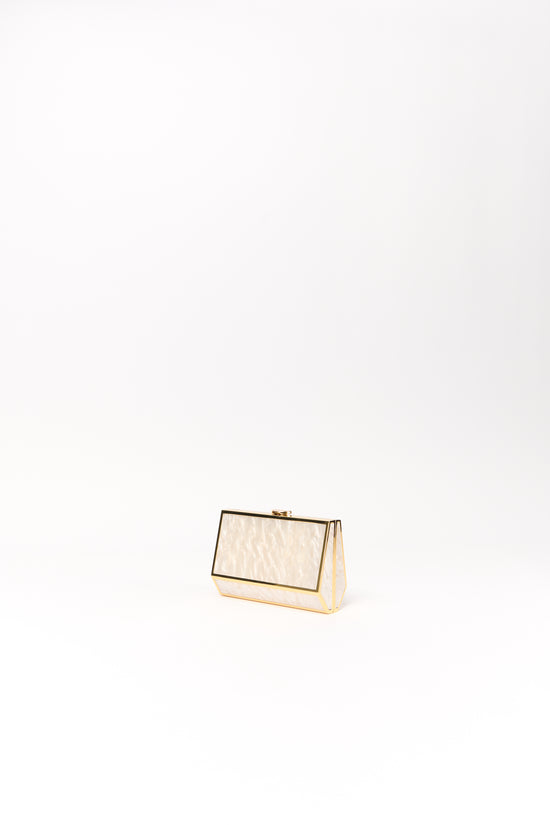Cream and gold rectangular clutch with textured front panel and metal frame closure.