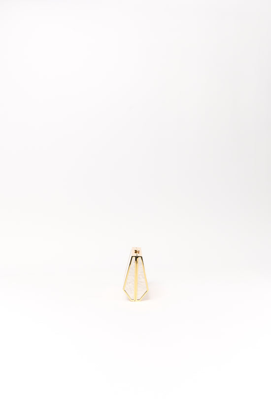 Small gold-toned clutch with geometric frame design and cream-colored fabric panels.