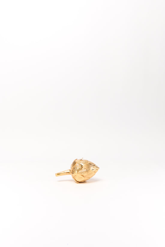 Gold-toned artichoke-shaped clutch with textured surface and handle against white background.