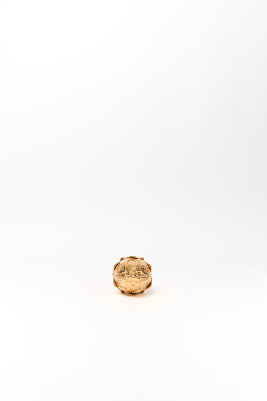 Gold-toned spherical clutch with textured artichoke-like surface and top closure clasp.