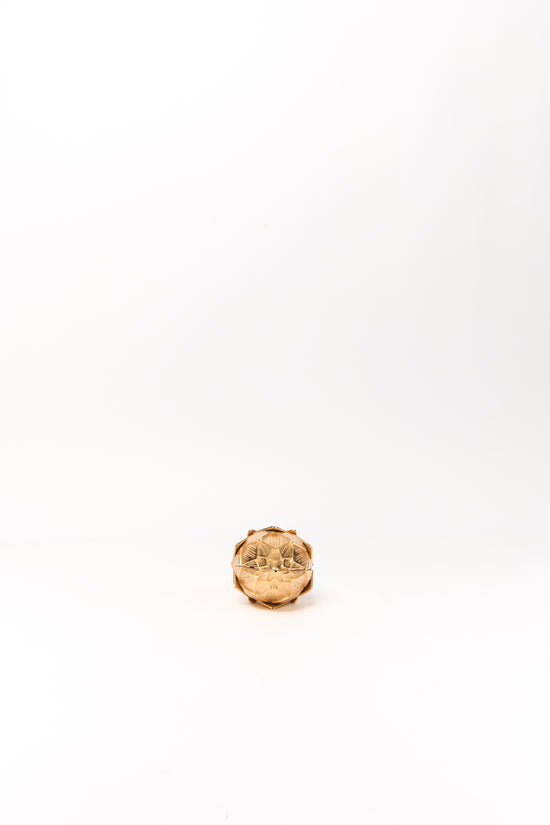 Gold-toned spherical clutch with textured artichoke-like surface and top closure clasp.