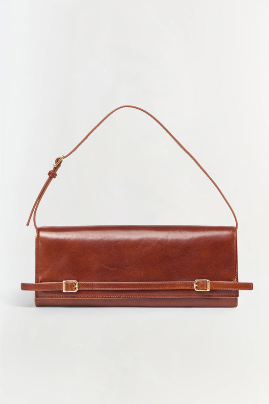 Brown leather clutch with single shoulder strap and two gold-tone buckle details across the front.