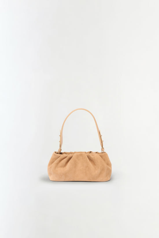 Tan suede shoulder bag with gathered fabric body and curved handles.