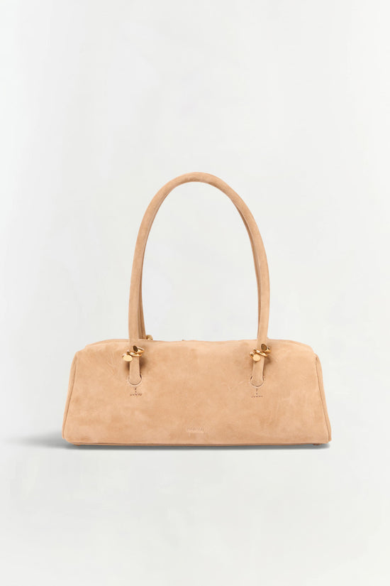 Tan suede shoulder bag with dual handles and gold-tone hardware on a neutral background.