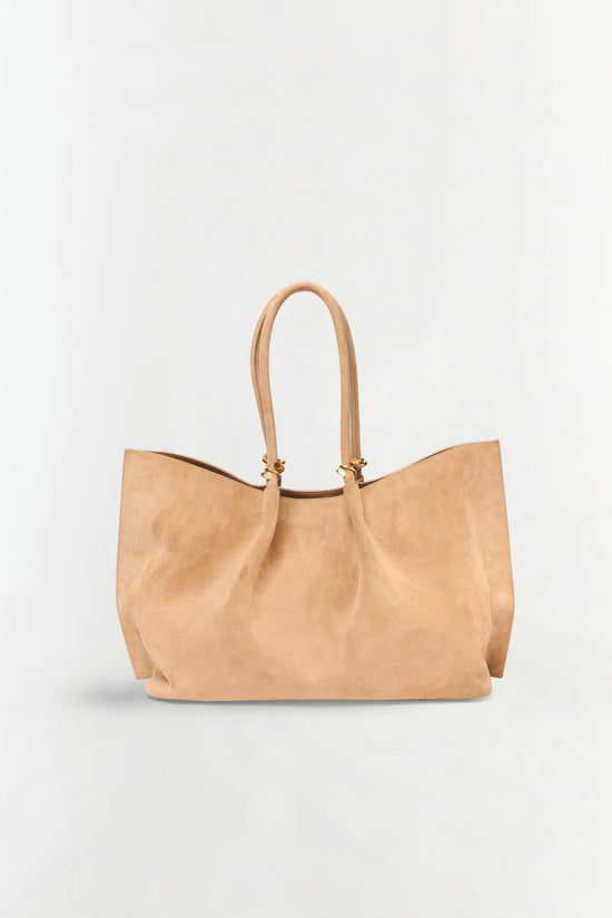 Tan suede tote bag with dual handles and brown trim accent at the opening.