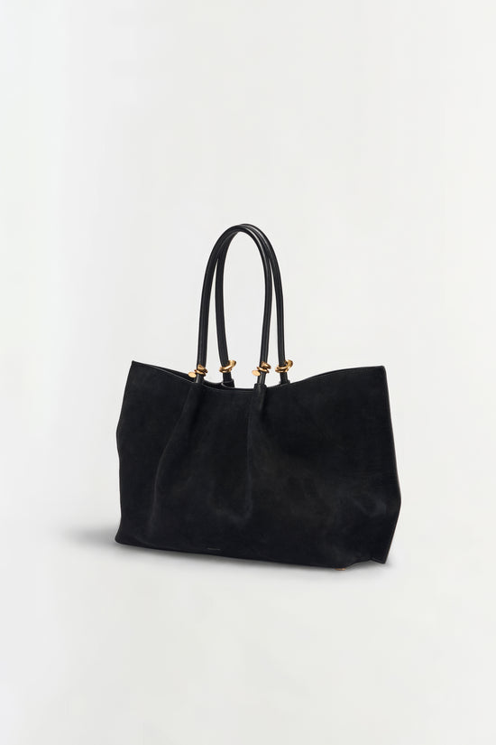 Black suede tote bag with dual handles and gold-tone hardware.