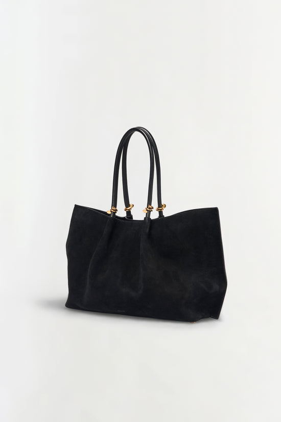 Black suede tote bag with dual handles and gold-tone hardware.