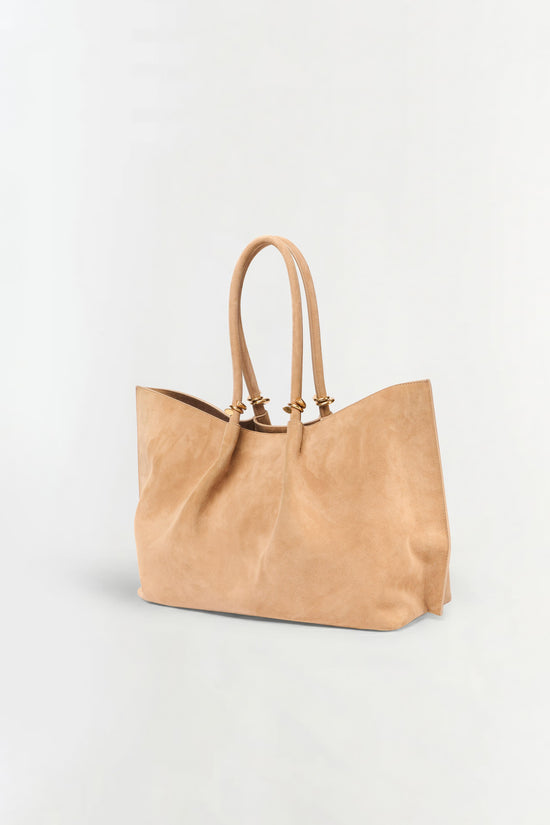 Tan suede tote bag with dual handles and brown interior lining.