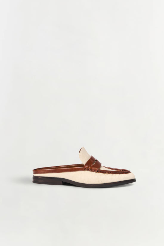 Cream canvas and brown leather loafer mule with black sole, shown in side profile.