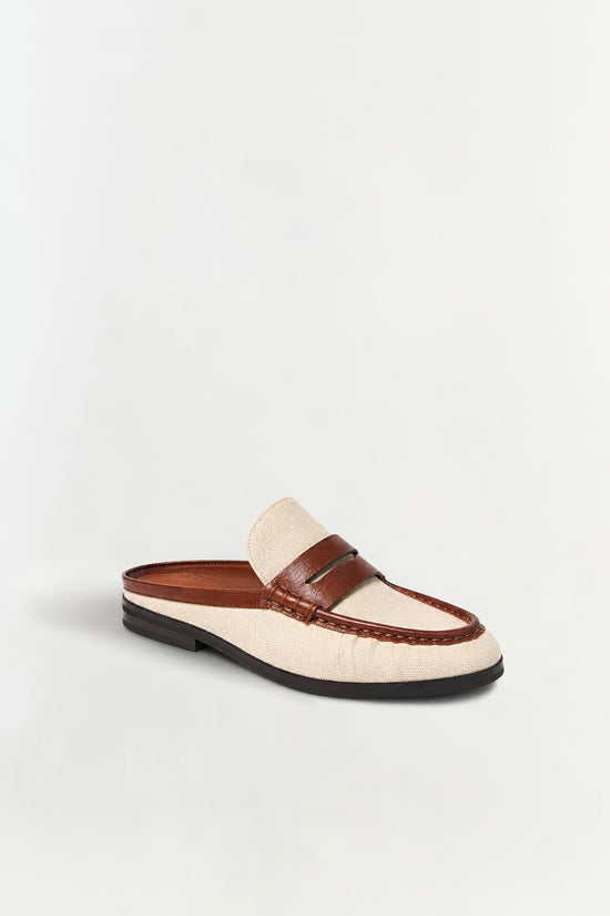 Cream canvas and brown leather loafer mule with black sole and decorative stitching detail.