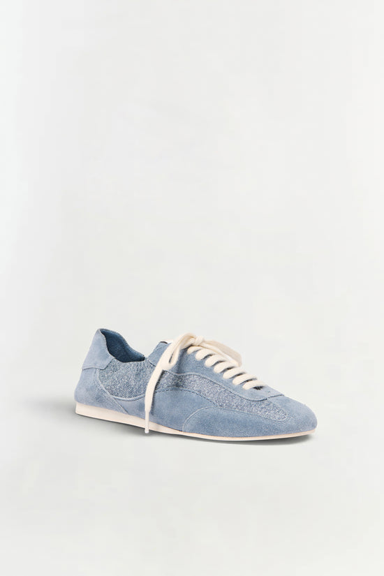 Blue denim and leather sneaker with white laces and cream sole, shown in side profile.