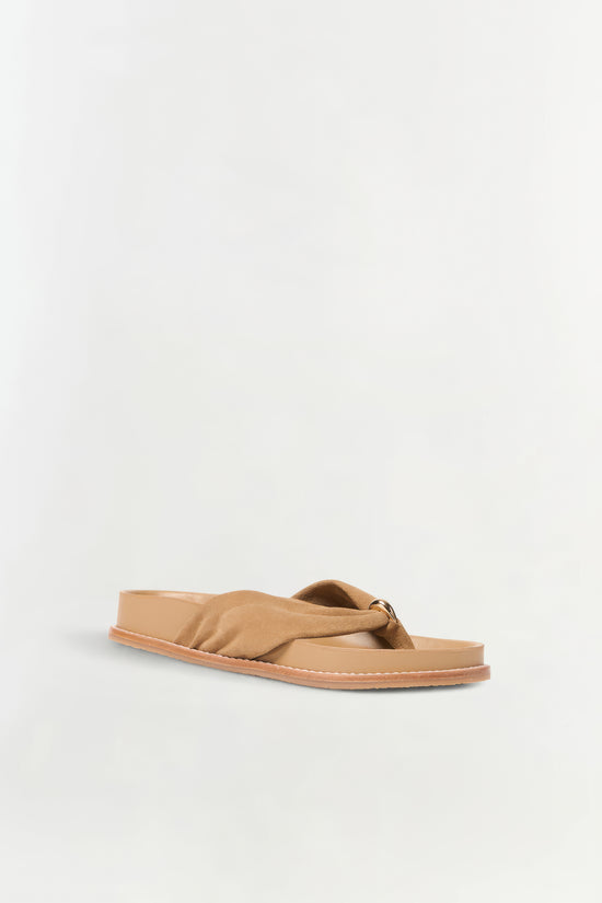 Tan suede sport sandal with twisted strap and flat sole, shown from the side.