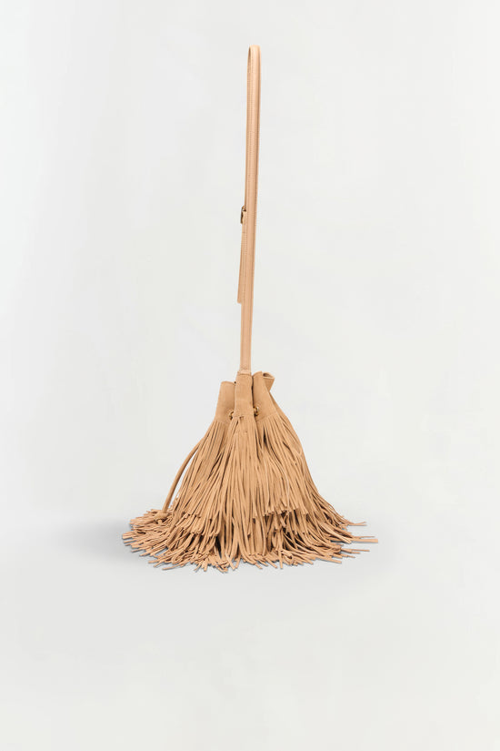 Tan suede crossbody bag with long fringe detail at bottom and adjustable shoulder strap.