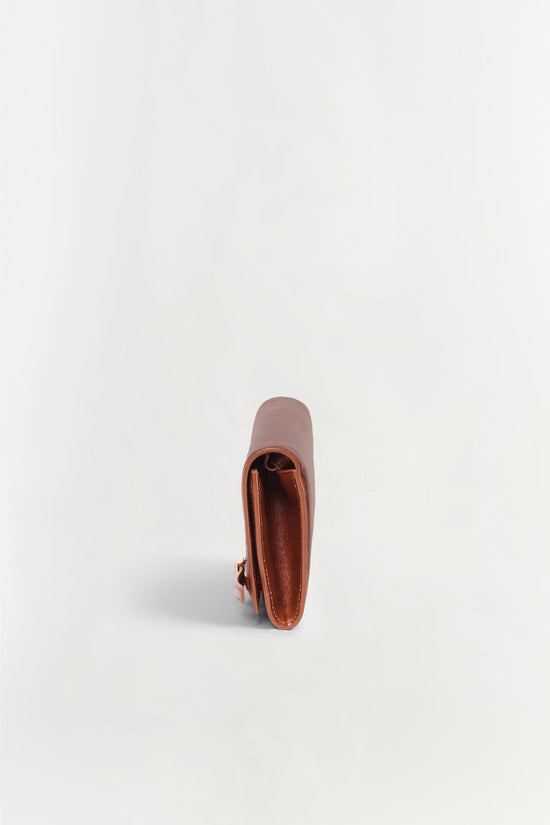 Tan and rust leather clutch with open front compartment, shown from above on white background.