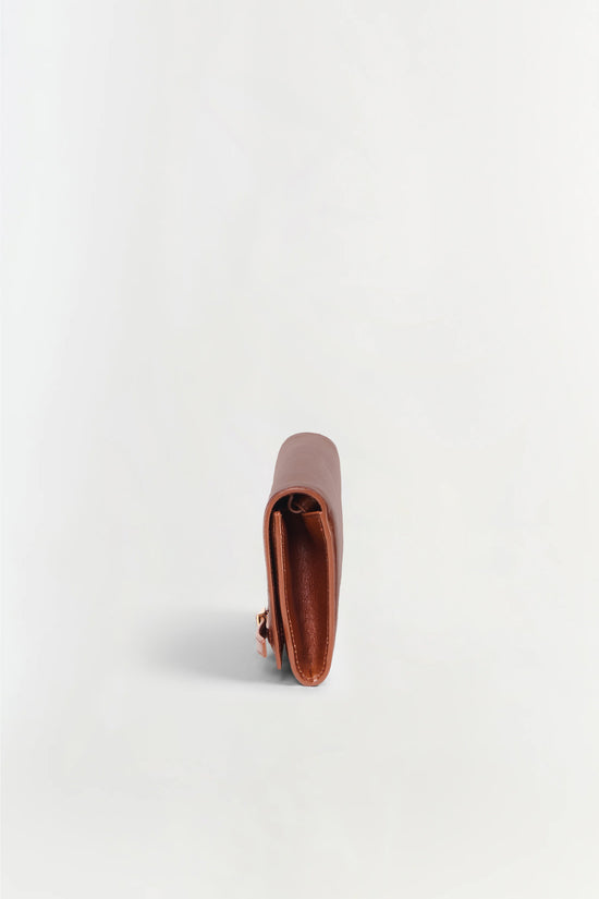 Tan and rust leather clutch with open front compartment, shown from above on white background.