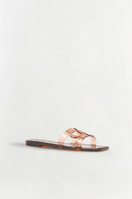 Clear translucent jelly slide with monogram cutout detail and tortoiseshell sole.