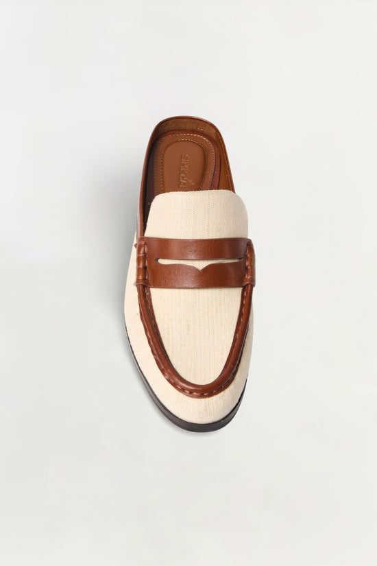 Brown leather and cream canvas loafer mule with dark sole, shown from above.