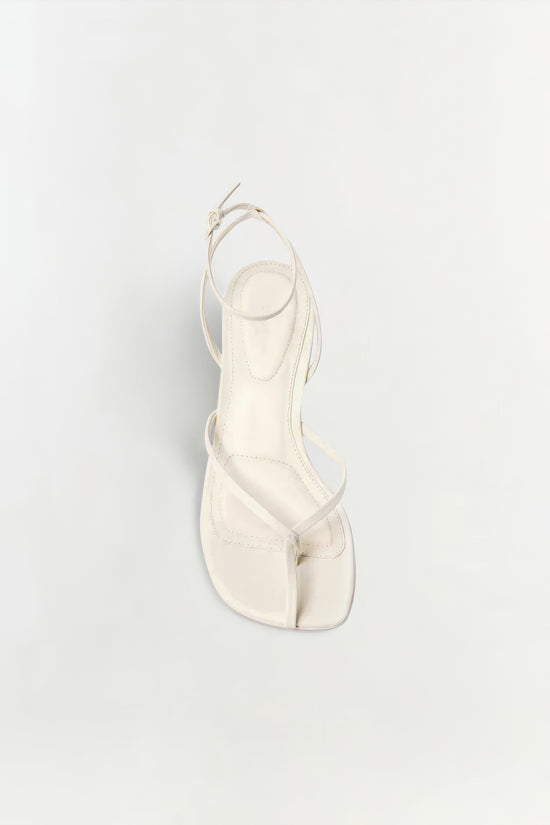 Cream leather strappy wedge sandal with ankle strap and square toe, shown from above.